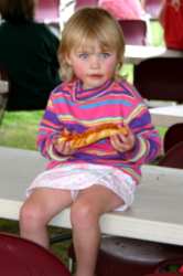 A cute little girl enjoys some pizza
