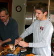 Dad shows John how to carve the turkey