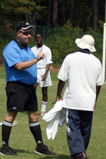 Ref talks to the Kickers coach