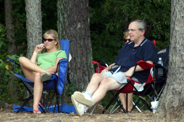 Parents watch from the cool woods