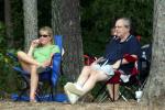 Parents watch from the cool woods