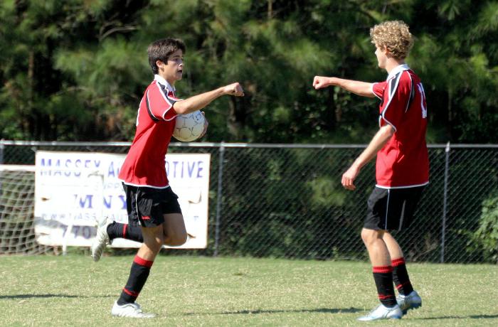Goal-scorer Ben takes the ball back to the centerline
