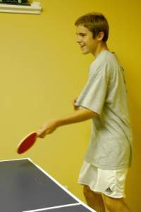 Inside, Chancey plays ping-pong...