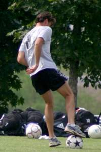 Coach retrieves a ball