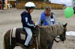 This young man enjoyed his ride on a tiny pony