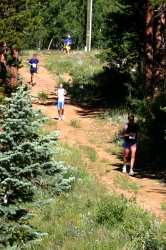 Here comes John out of the woods (blue shorts)
